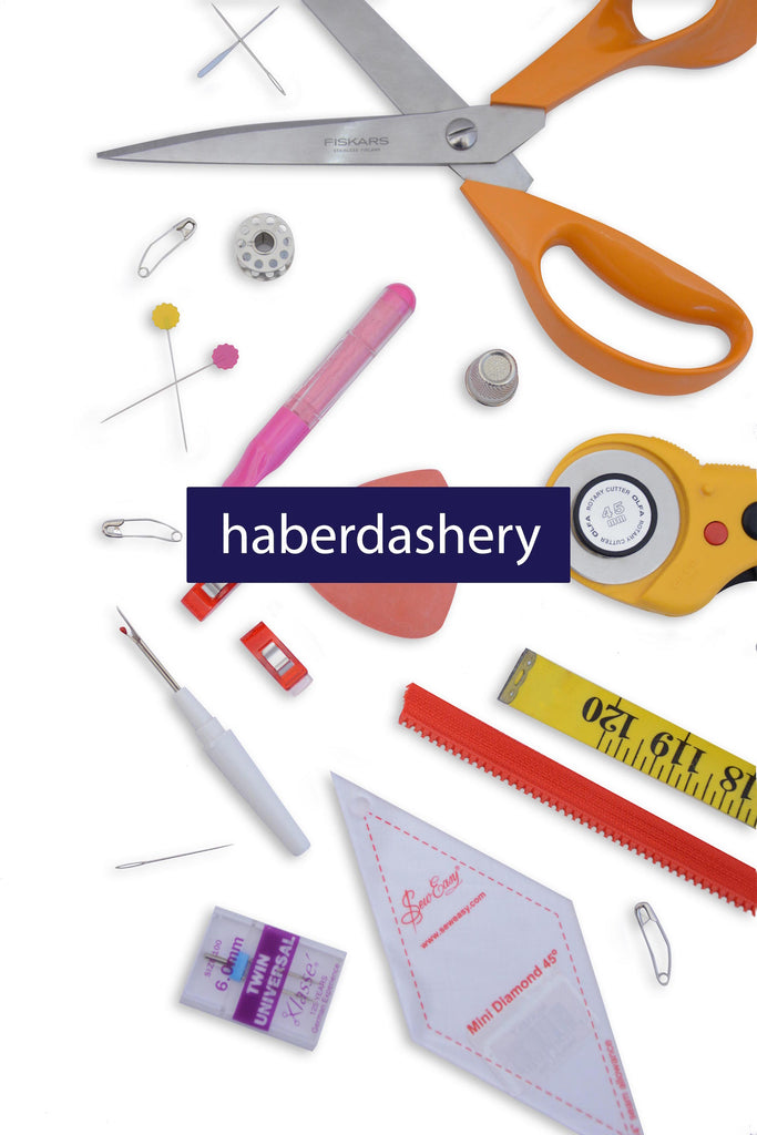 marking tools scissors clips, unpickers, tape measures, zips, haberdashery scattered on a white background pins at the eternal maker